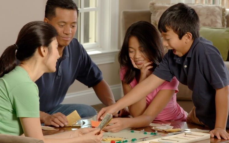 Family playing Monopoly