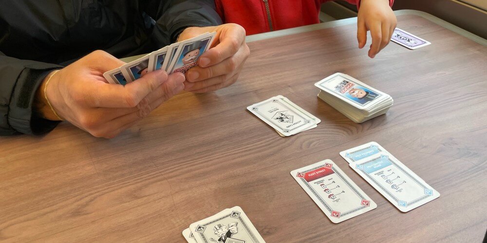 Playing Monopoly Deal on a train