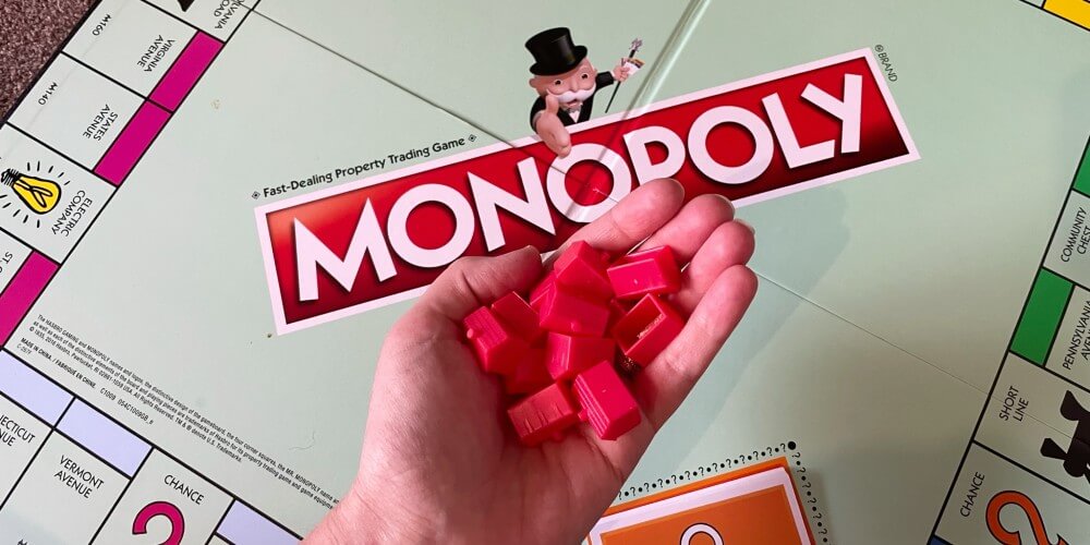 a hand holding monopoly hotels