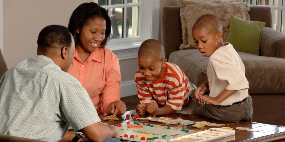 Family playing Monopoly