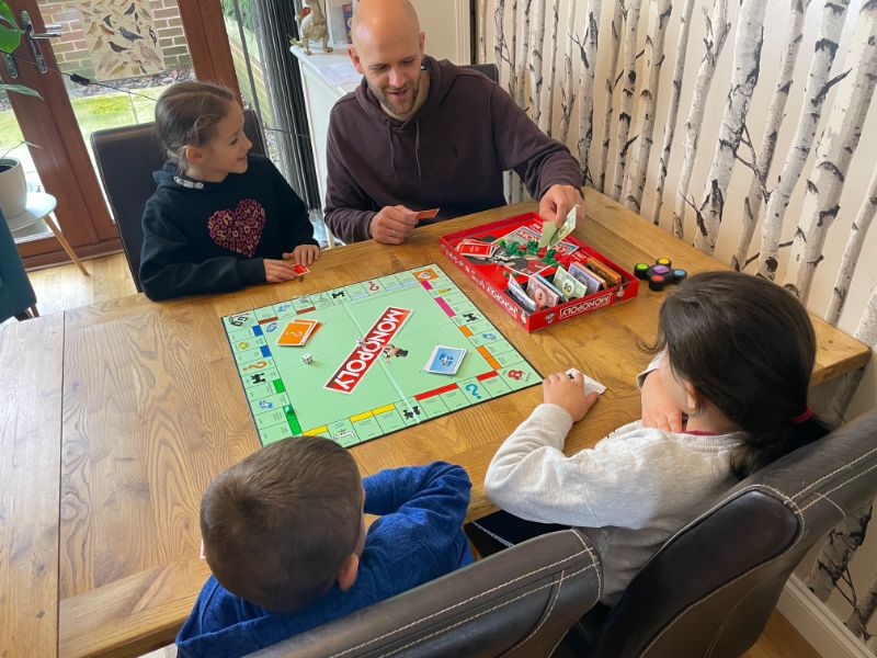 family playing Monopoly