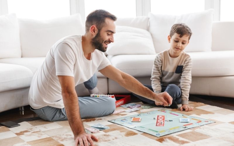 Dad and son playing Monopoly