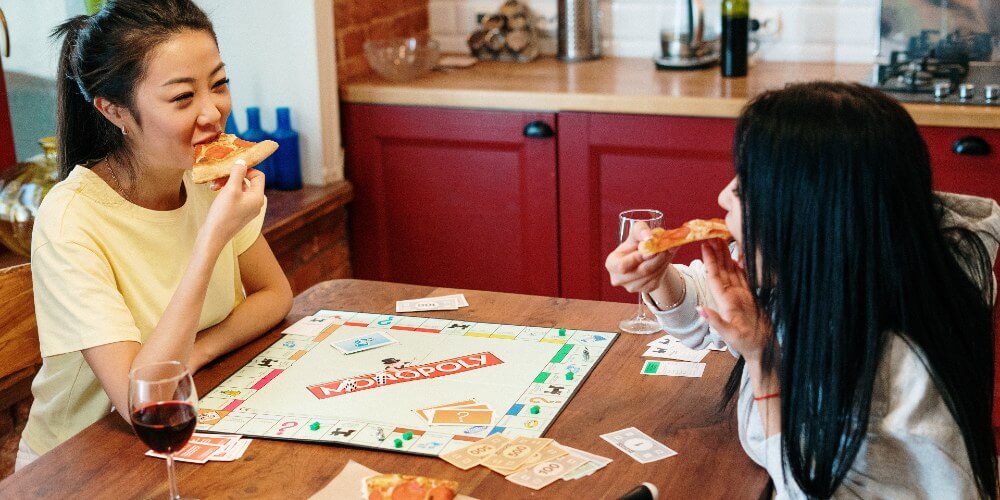 two women playing Monopoly