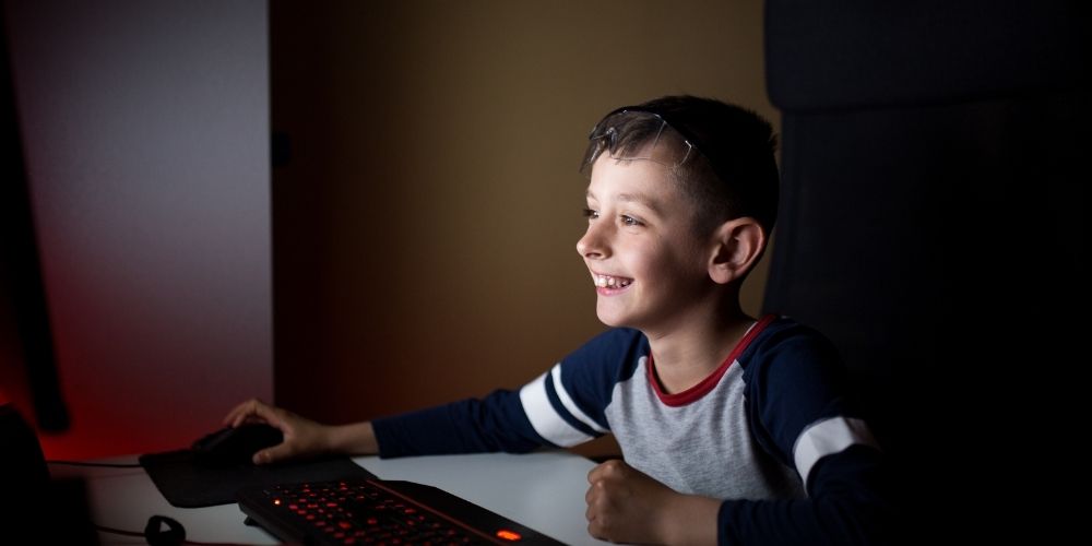 Kid playing Monopoly PC game