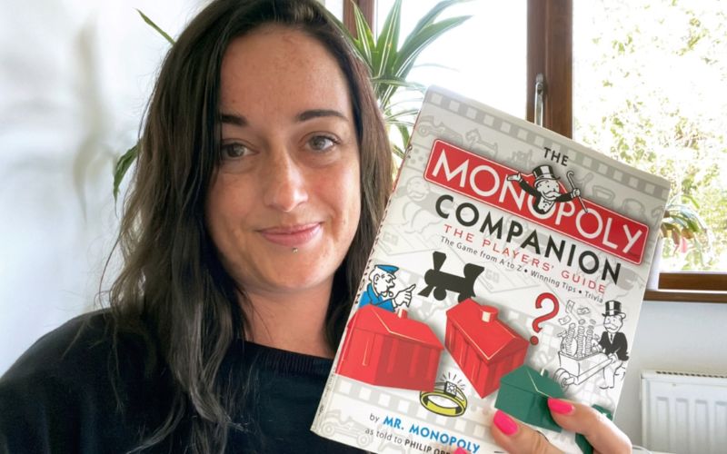 Jenni holding the Monopoly Companion book.