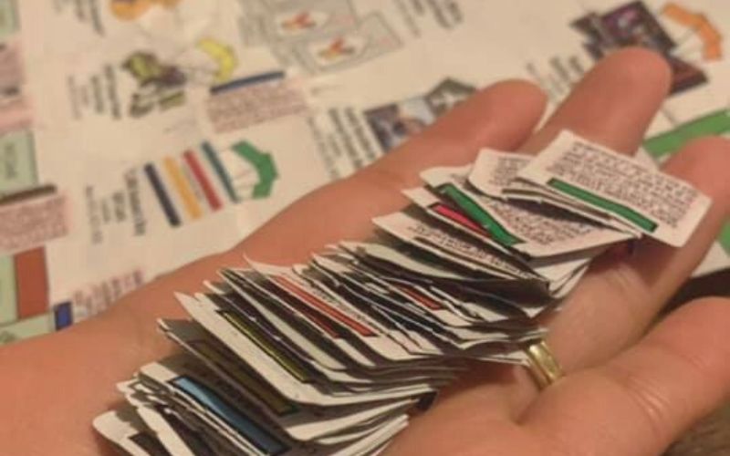 a hand holding mcdonalds canada monopoly stickers