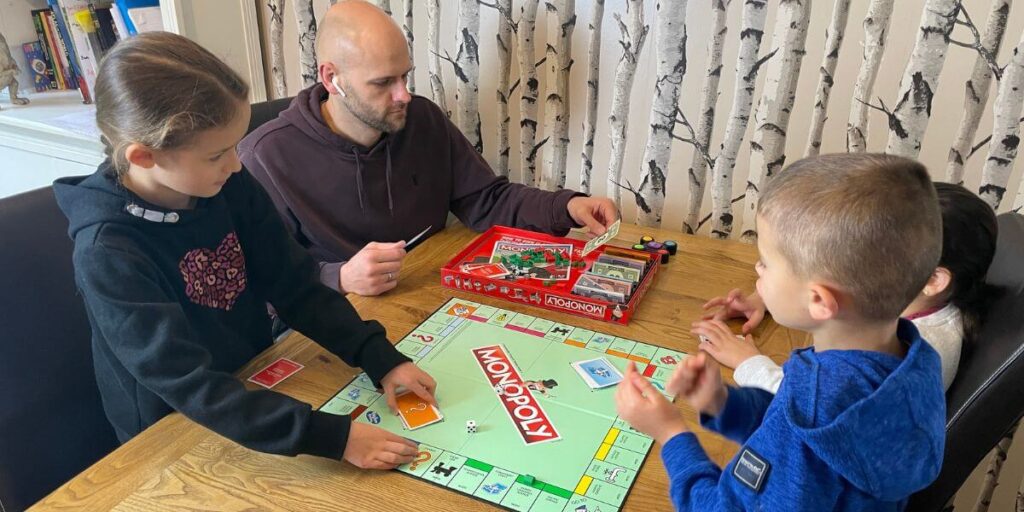 family playing Monopoly