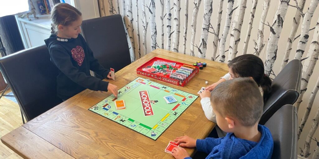 seven year olds playing Monopoly